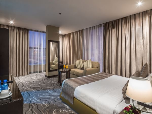 Spacious room with a bed and sofa in Executive Sea at Warwick Al Khobar