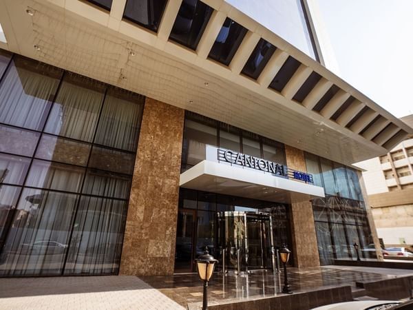 Cantonal Hotel by Warwick Riyadh entrance with glass revolving doors by stone pillars under a large white canopy