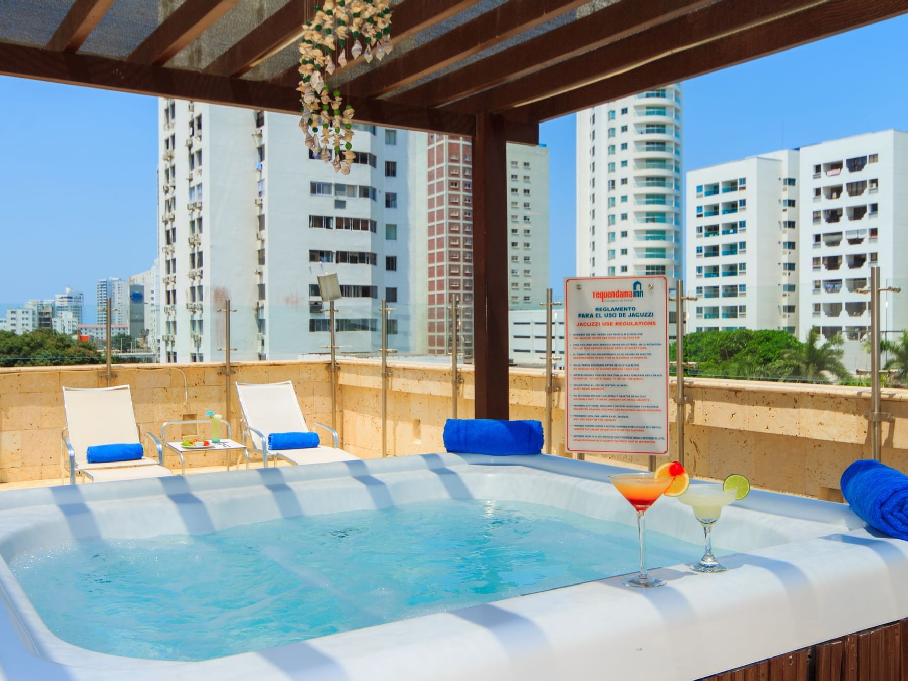 Cocktails by the jacuzzi with a city view at DOT Hotels
