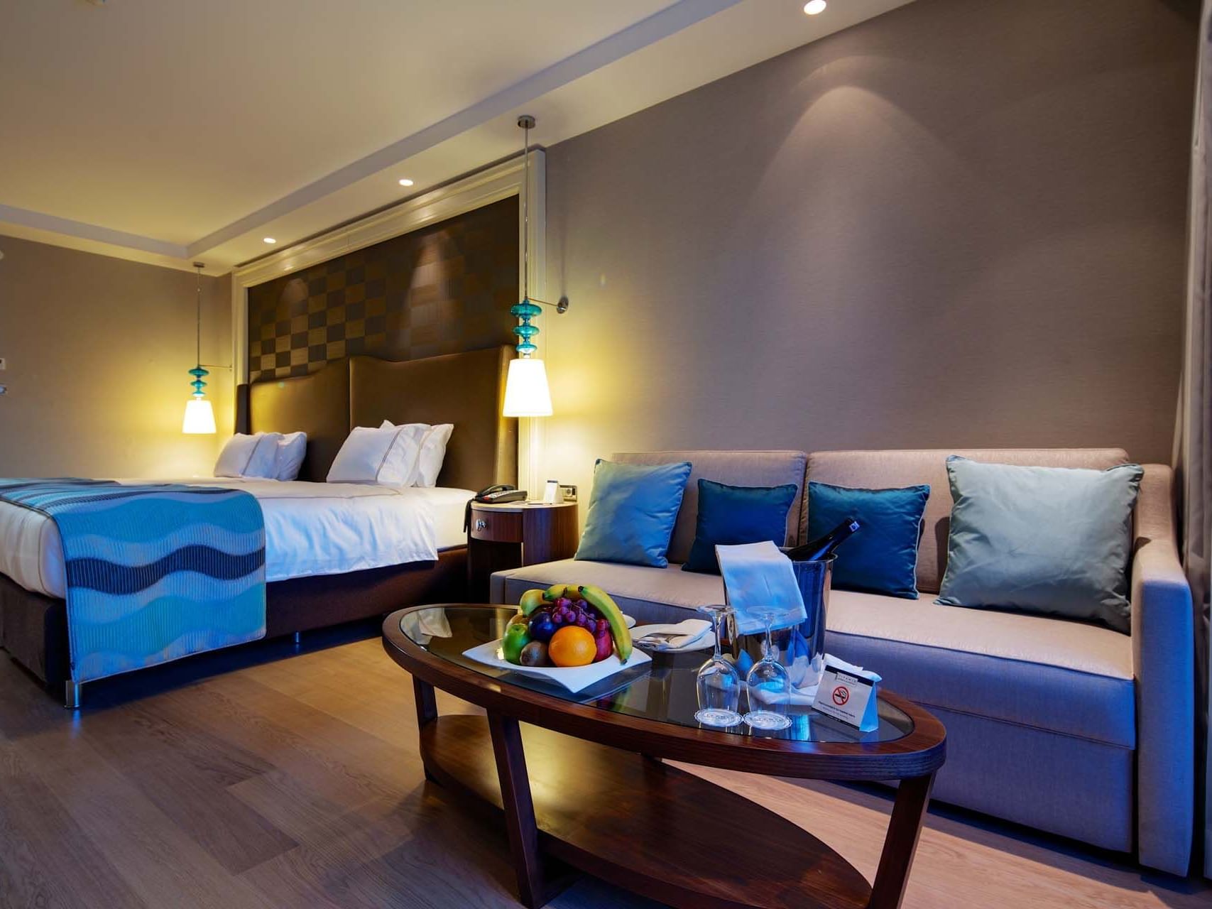 Sitting area by the beds in Standard Room with wooden floors at Titanic Deluxe Golf Belek