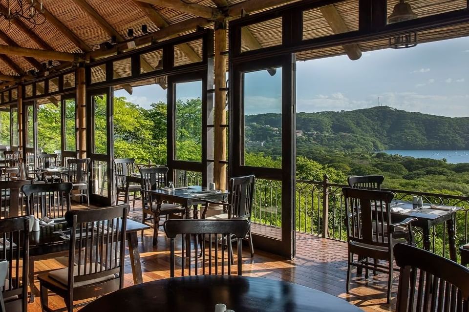 Dining area overlooking the outdoors from Bahía Restaurant at Villas Sol Beach Resort