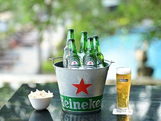 A bucket filled with ice and Heineken beer bottles, perfect for a party or gathering