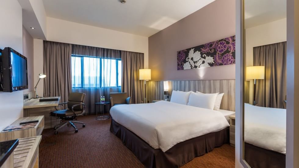 Twin beds, work area & TV with city view in Deluxe Twin at Sunway Hotel Big Box