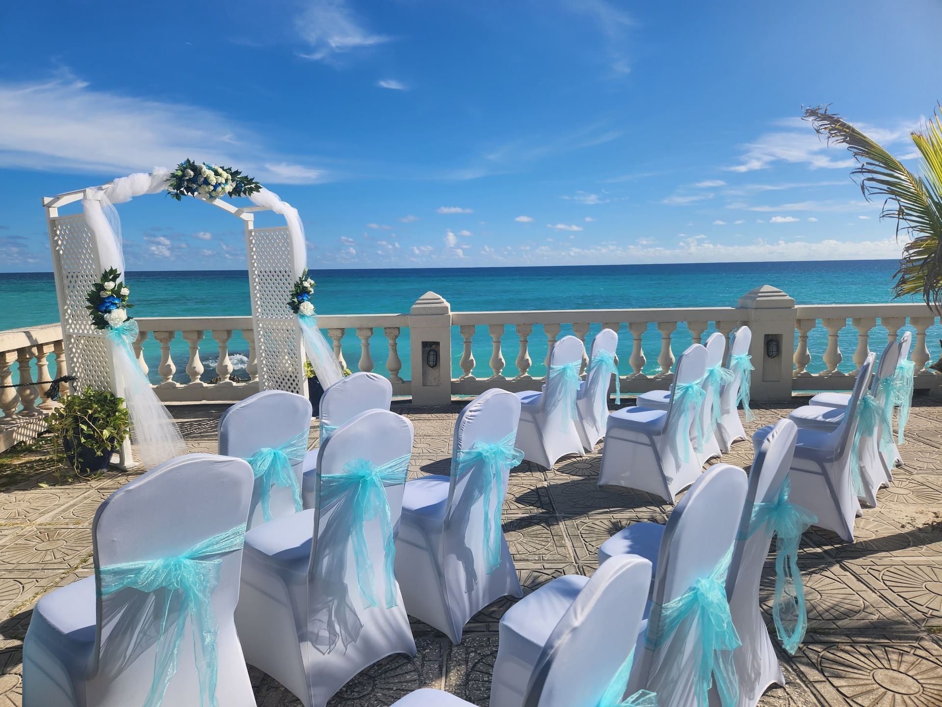 Outdoor wedding ceremony with chairs with blue and white décor at Dover Beach Hotel
