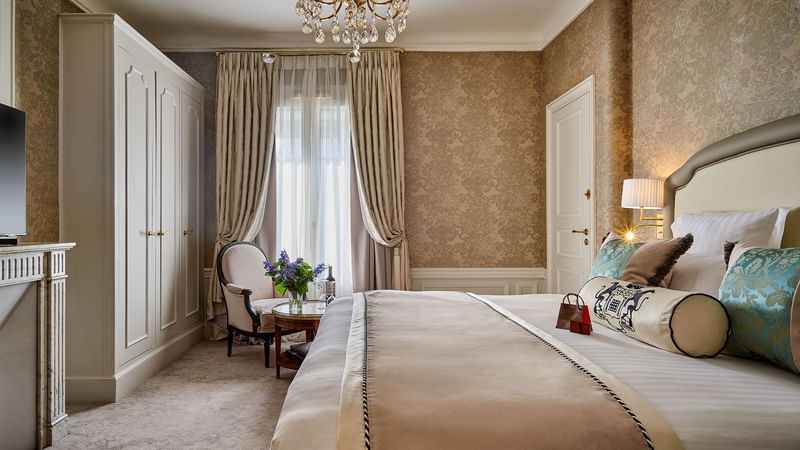 Elegant Executive Room with queen bed and a chair by the window at Hôtel Westminster - Paris