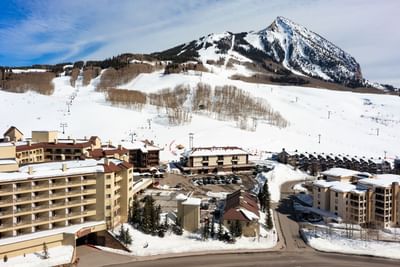 Aerial view of Elevation Resort & Spa with snow-covered mountain backdrop at Elevation Resort Spa
