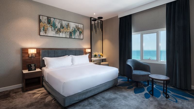 Bed with nightstands and couch in Executive Room Sea View at Warwick Hotels & Resorts