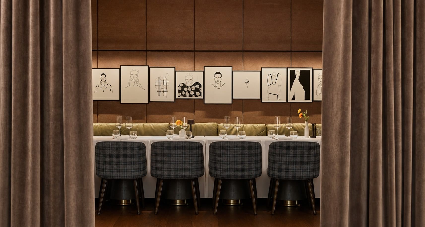 Private dining space in Whitcomb's with drawback curtains, plaid upholstered chairs & framed artwork at The Londoner Hotel