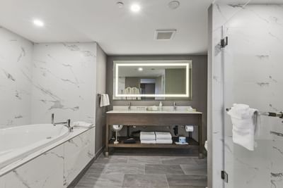 A bathroom with marble design walls at Best Western Premier