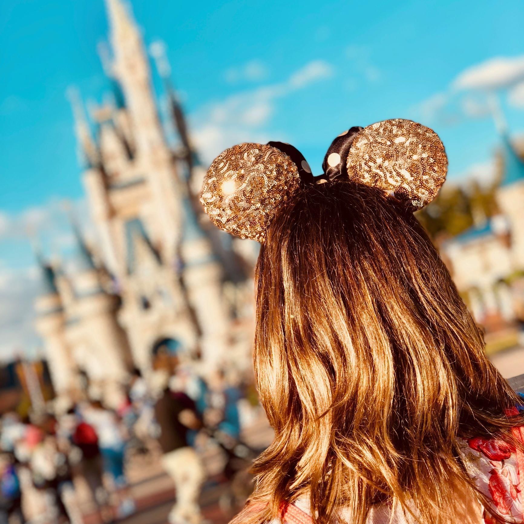 Girl with Disney ears in front of Disneyland near DOT Hotels