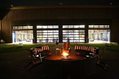 chairs and couches surrounding a firepit