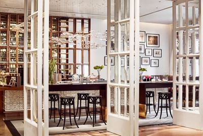Opera Bar with wooden shelves, framed art, and contemporary decor at Park Hyatt Saigon