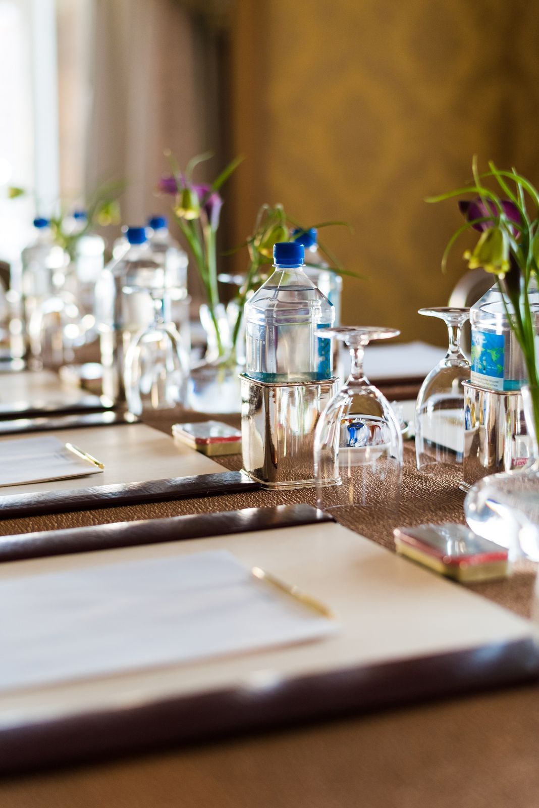 Conference room with flowers and pads of paper