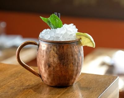 copper cocktail glass overflowing with icea