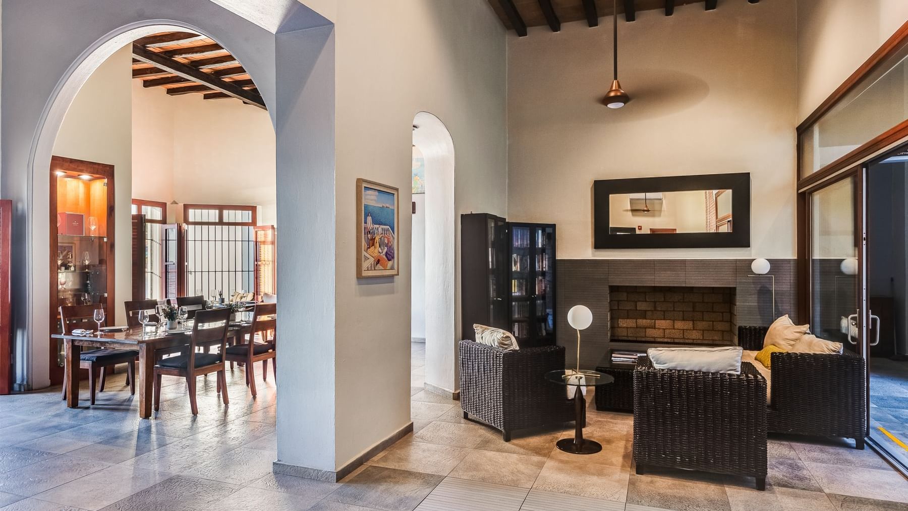 Cozy lounge area with fireplace and a formal dining room at Curamoria Collection