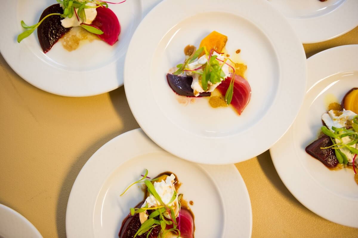 Close-up of various dishes served on white plates at Blackcomb Springs Suites