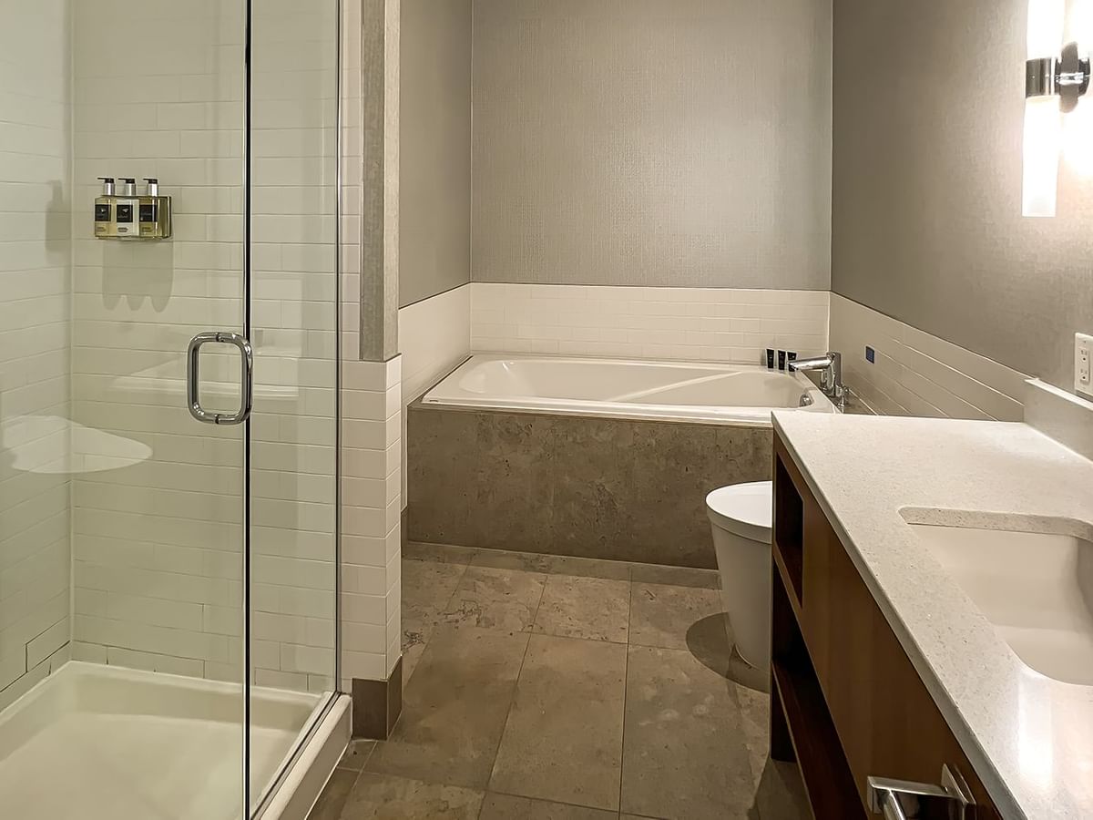Modern bathroom with large mirror, sink, bathtub, shower room, and toilet
