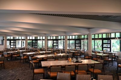 A wide shot of Osgood’s Restaurant at the Bolger Center featuring long tables and chairs in a well-lit space