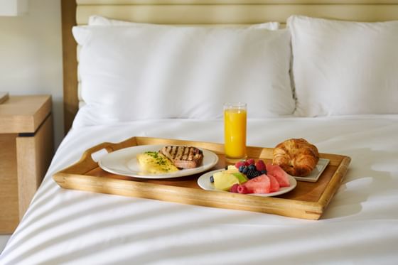 Breakfast with fresh juice served on a bed at Luxe Sunset Boulevard Hotel