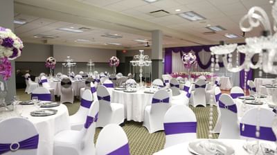 White and purple themed seating arranged in Banquet at Fort McMurray Hotel