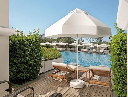 Sun loungers on pool deck at Family Pool Suite Swim-up in Titanic Deluxe Golf Belek
