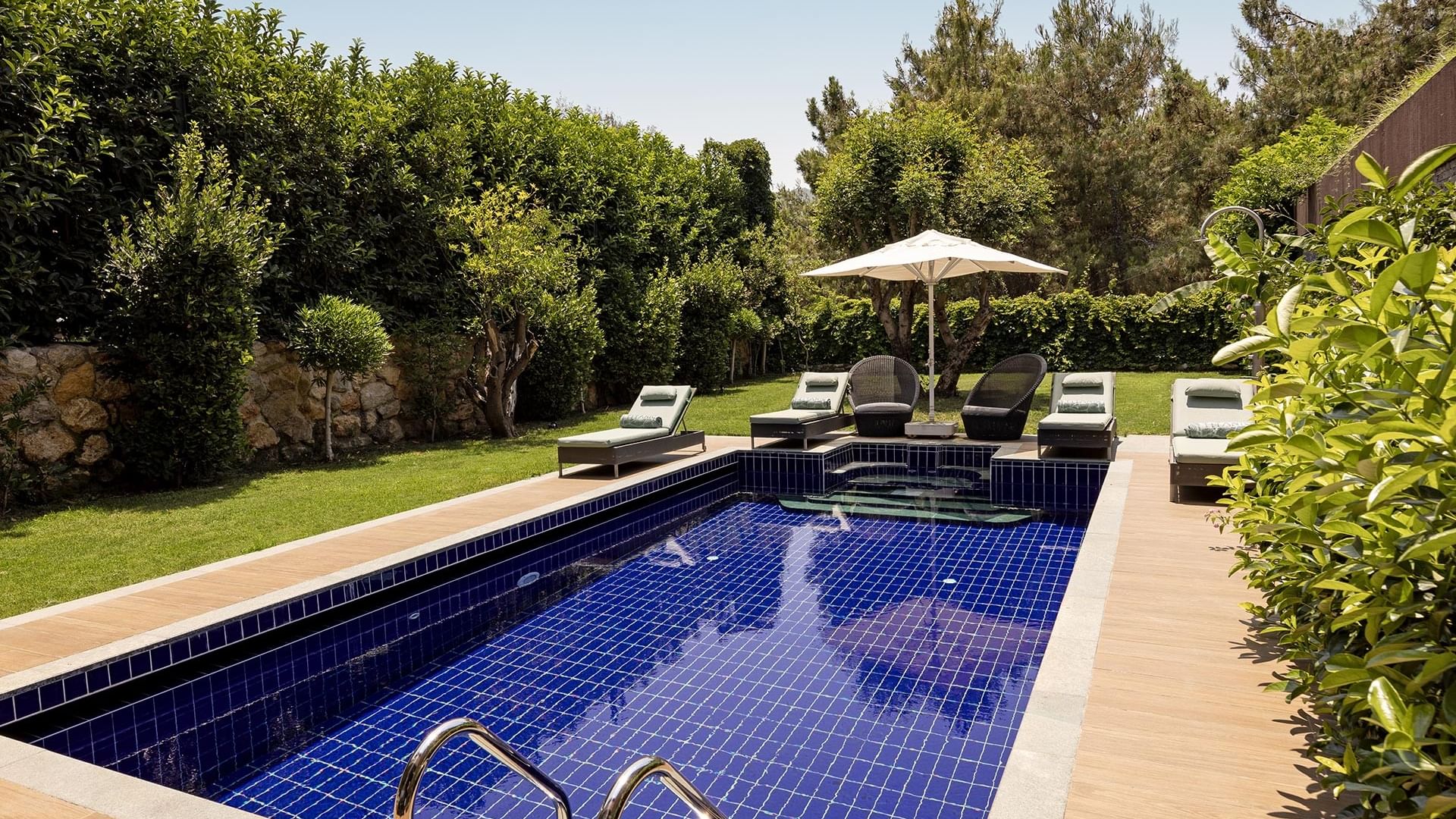 Эксклюзивная вилла с частным бассейном, шезлонгами, зонтиками и окружённая зеленью в Titanic Luxury Collection Bodrum