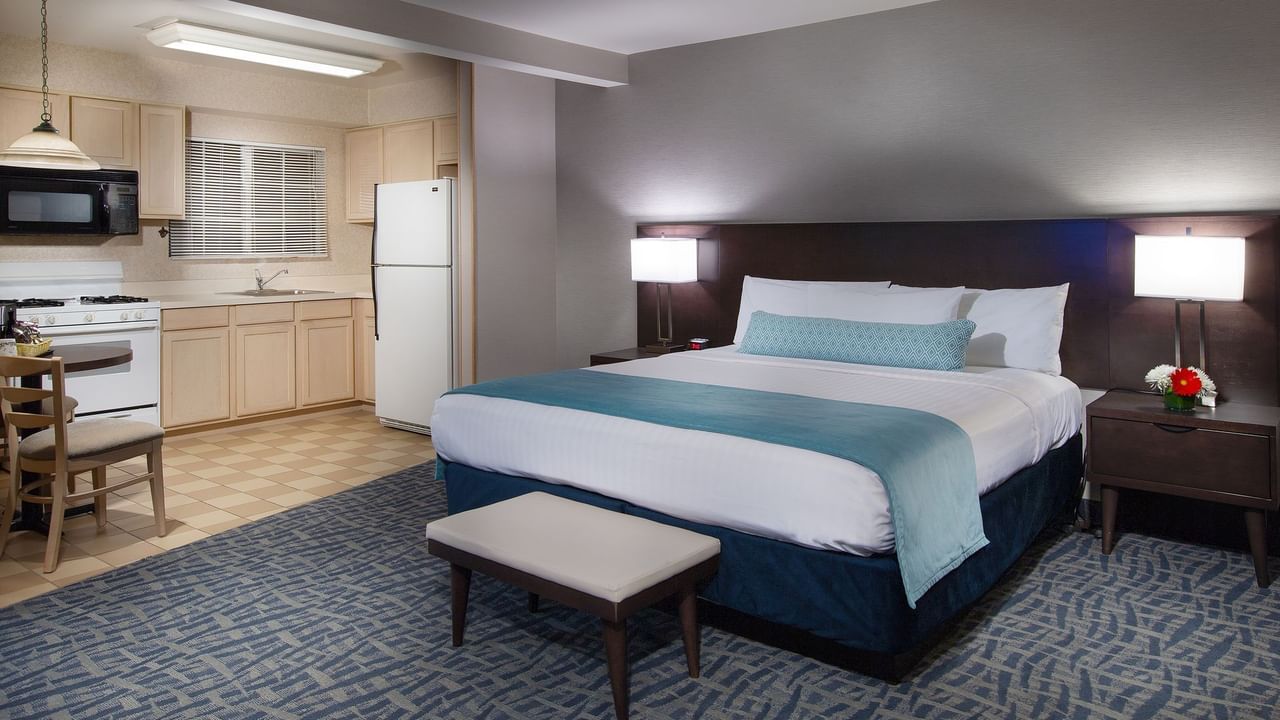 A Coast King Junior Suite bedroom and kitchenette