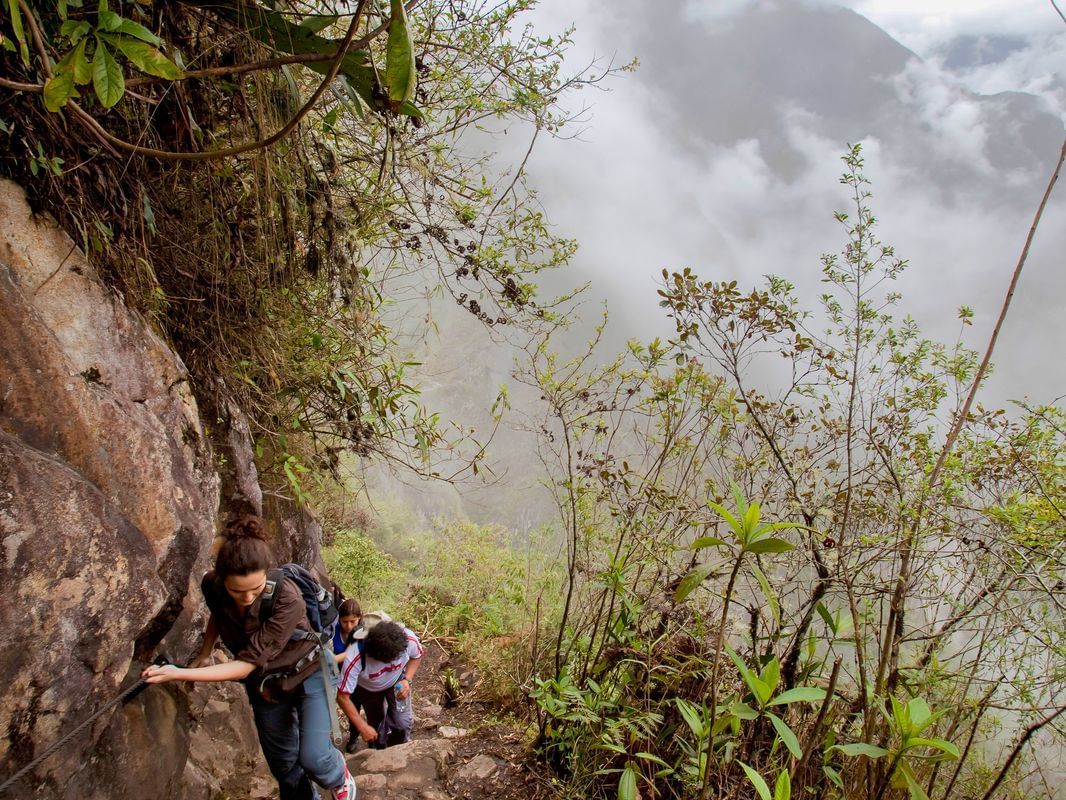 Tourists climbing the Machu Picchu Mountains near Hotel Sumaq