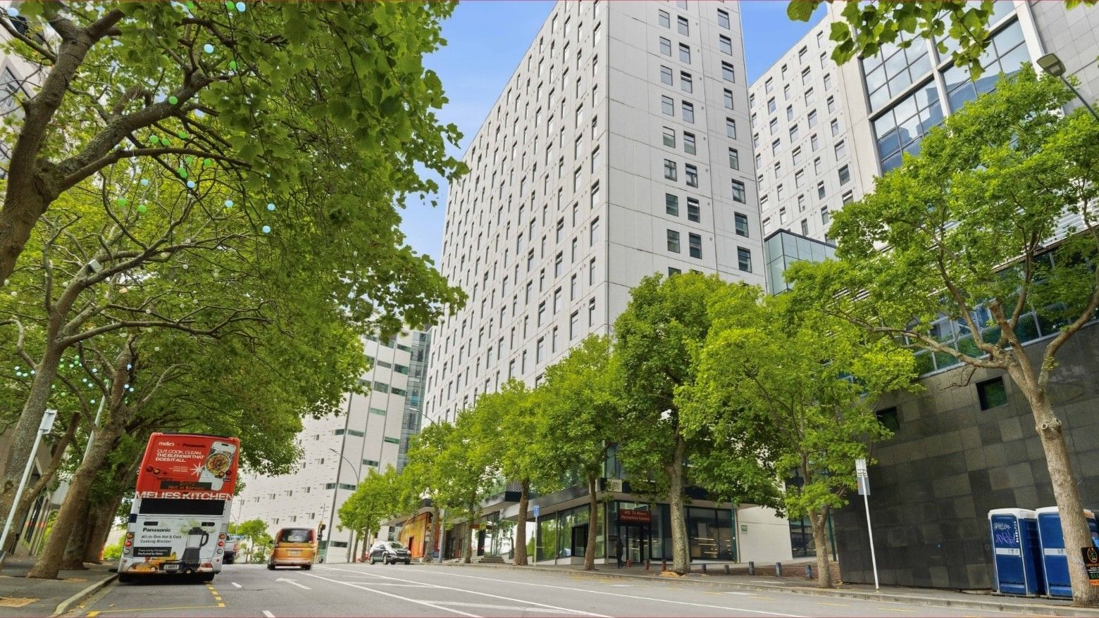 Street view of Mayoral Drive Student Accommodation with trees and passing vehicles.