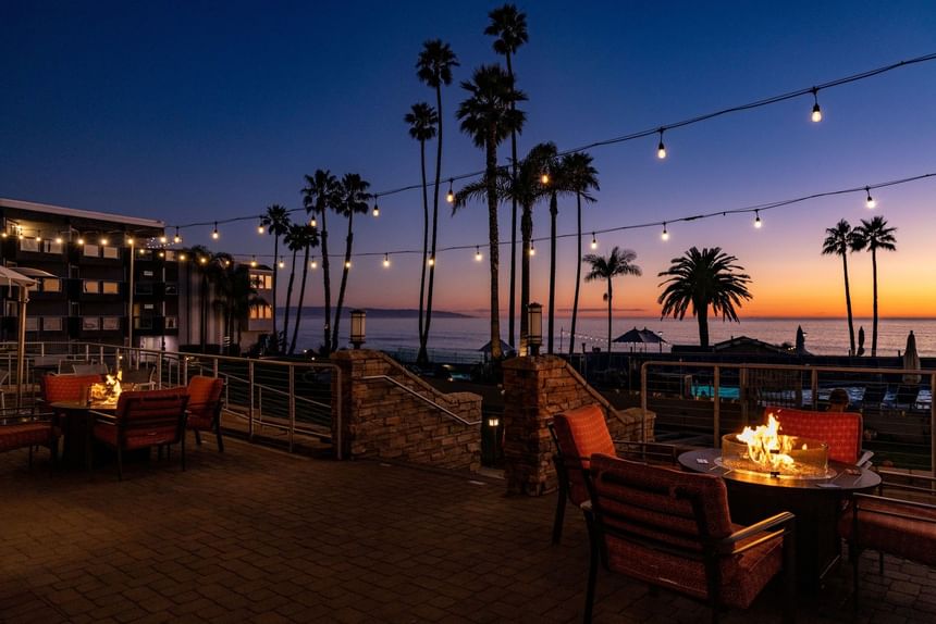 Hotel terrace fire pit with seating at sunset 