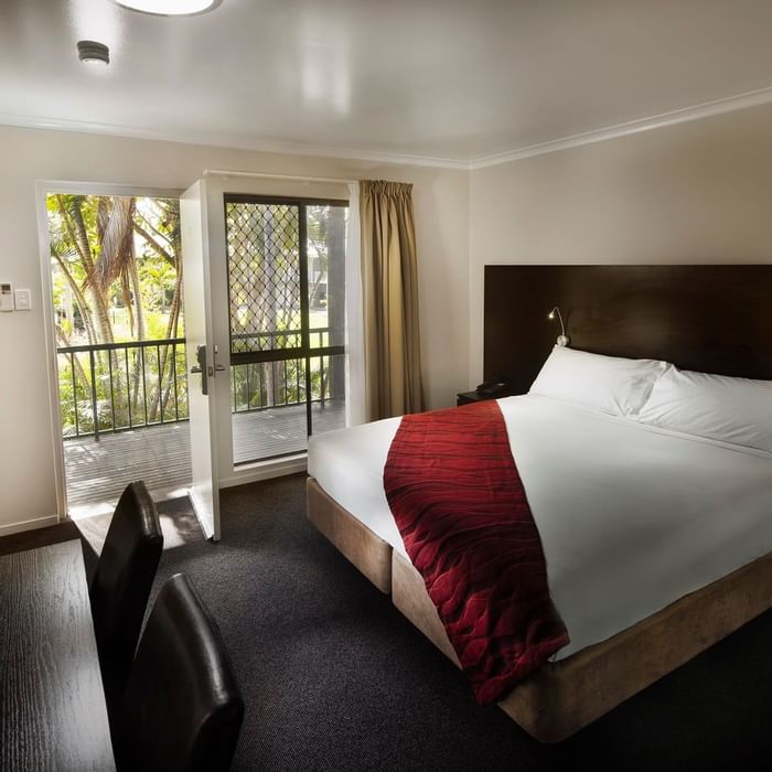 Premium Room featuring a queen bed, desk, and door to a private balcony at Mercure Hotel Townsville