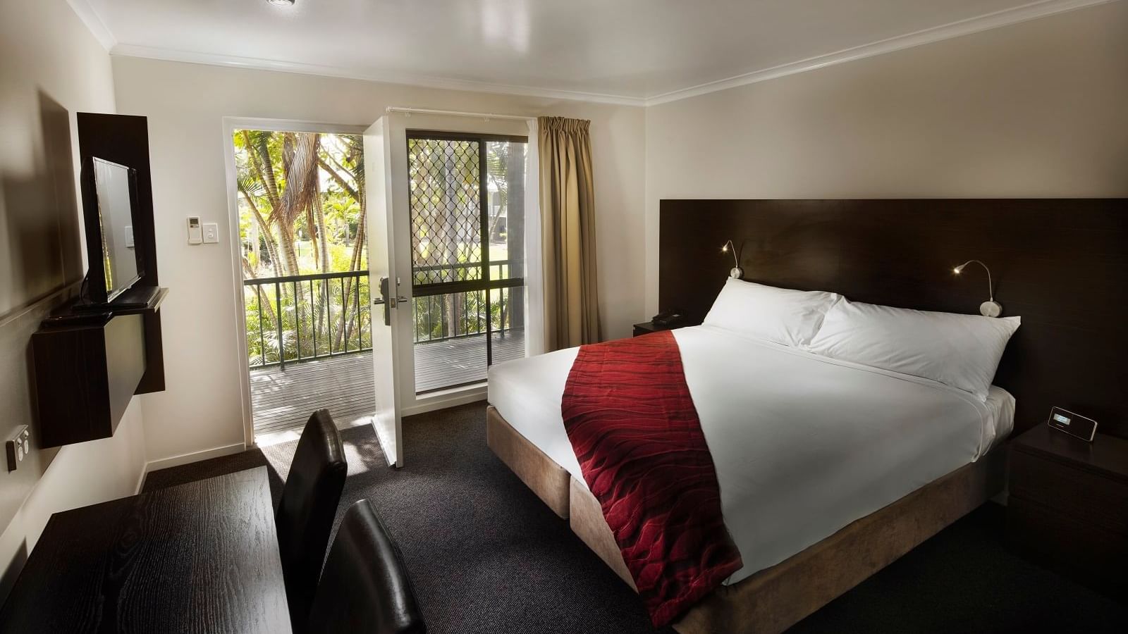 Premium Room featuring a queen bed, desk, and door to a private balcony at Mercure Hotel Townsville