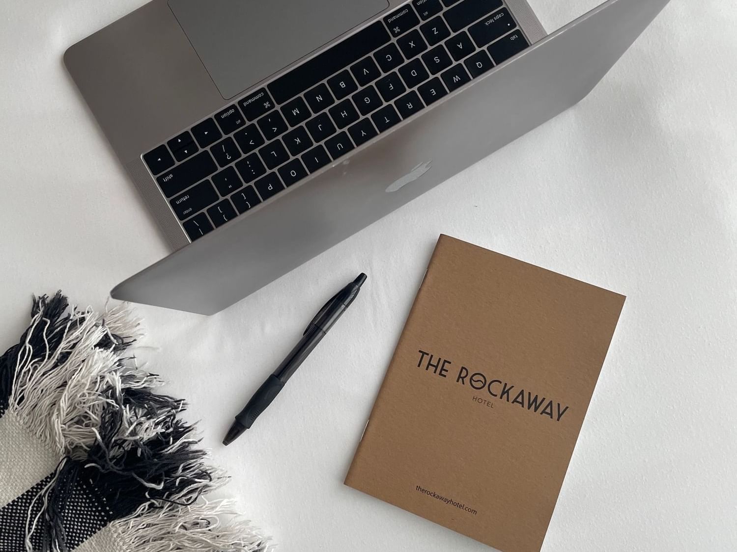 Laptop, pen & hotel notebook at The Rockaway Hotel