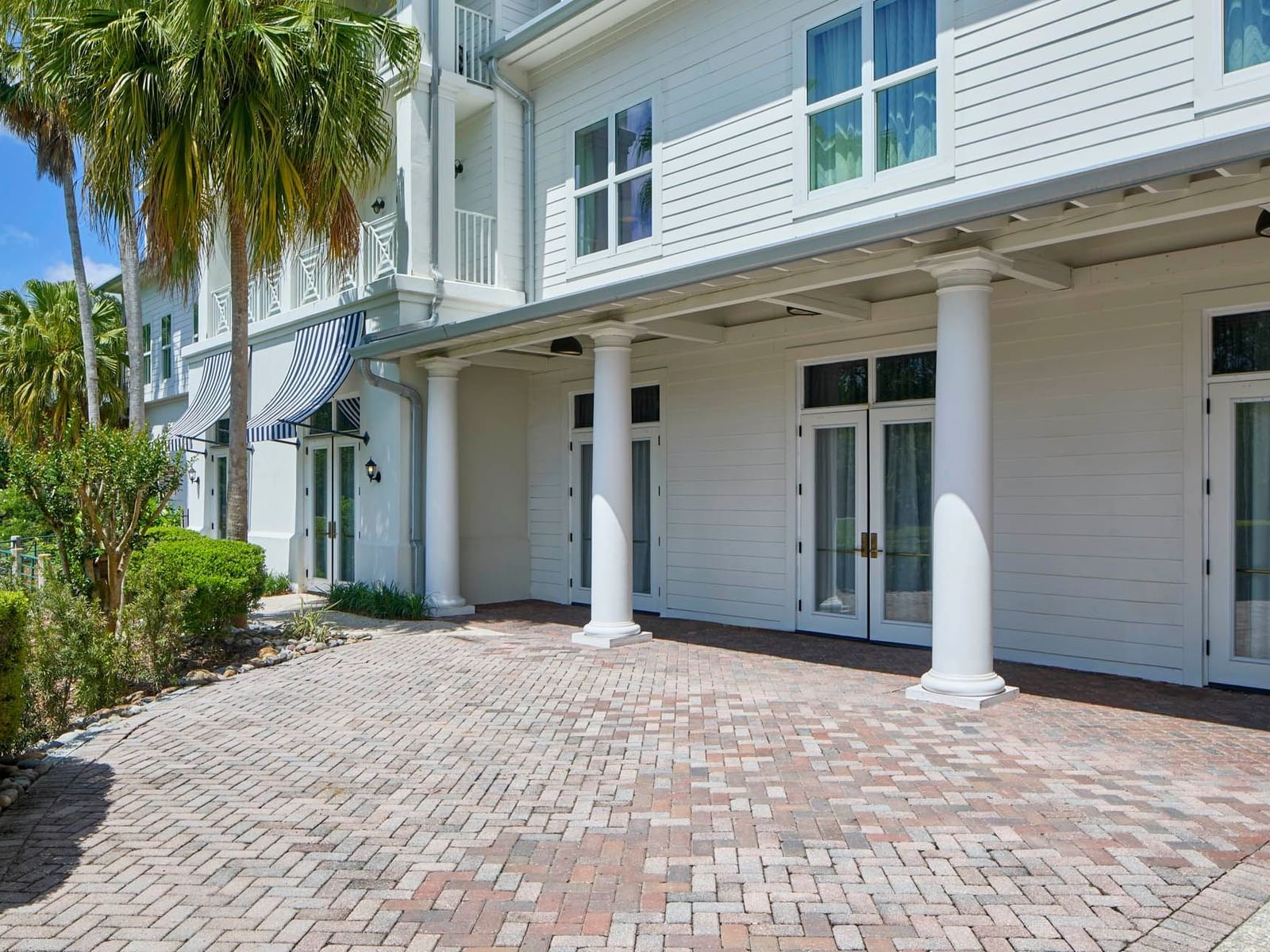 Celebration FL event space of Sabal Terrace with brick floor and white columns at the Inn at Celebration