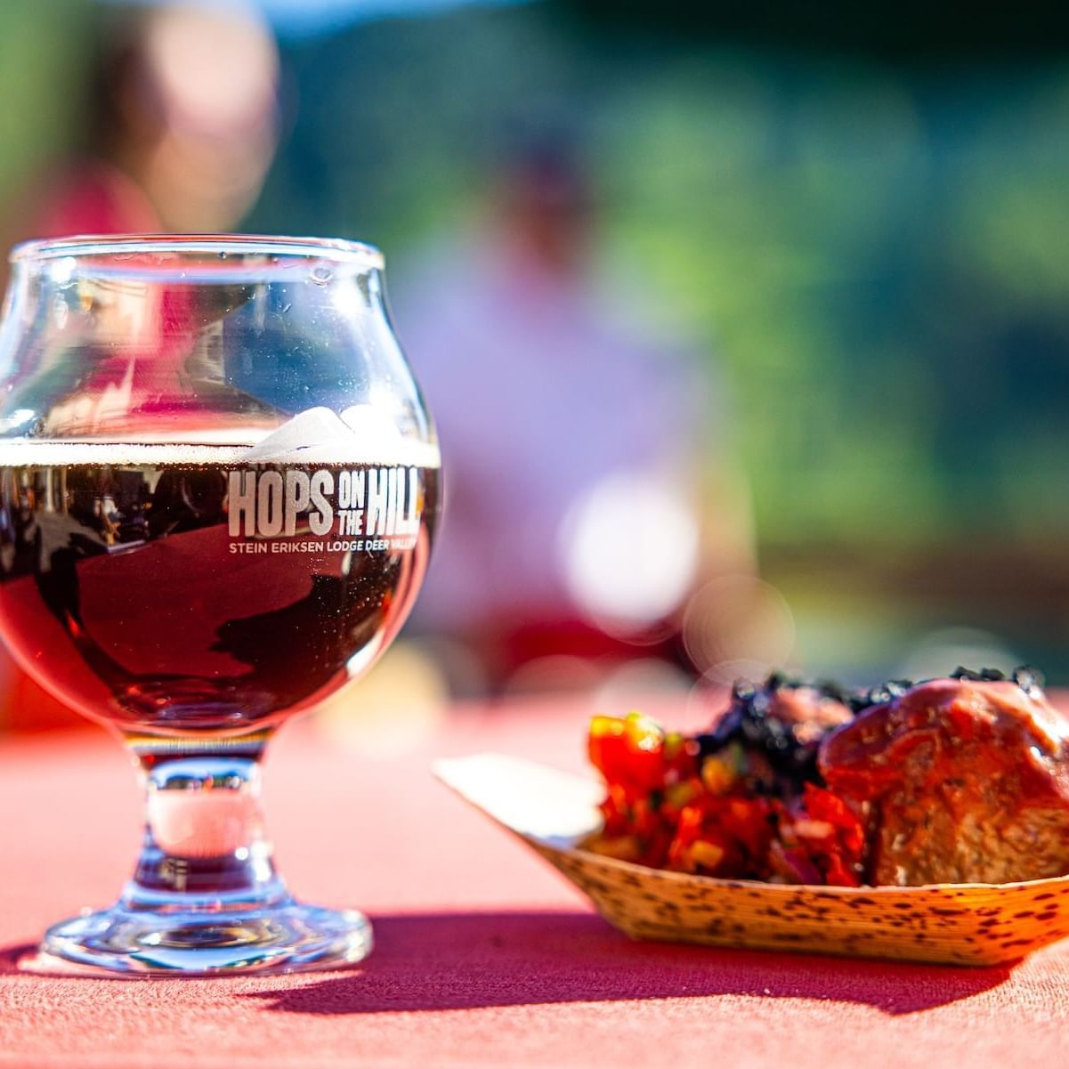Close-up of glass of beer and a plate of food served at Stein Eriksen Lodge
