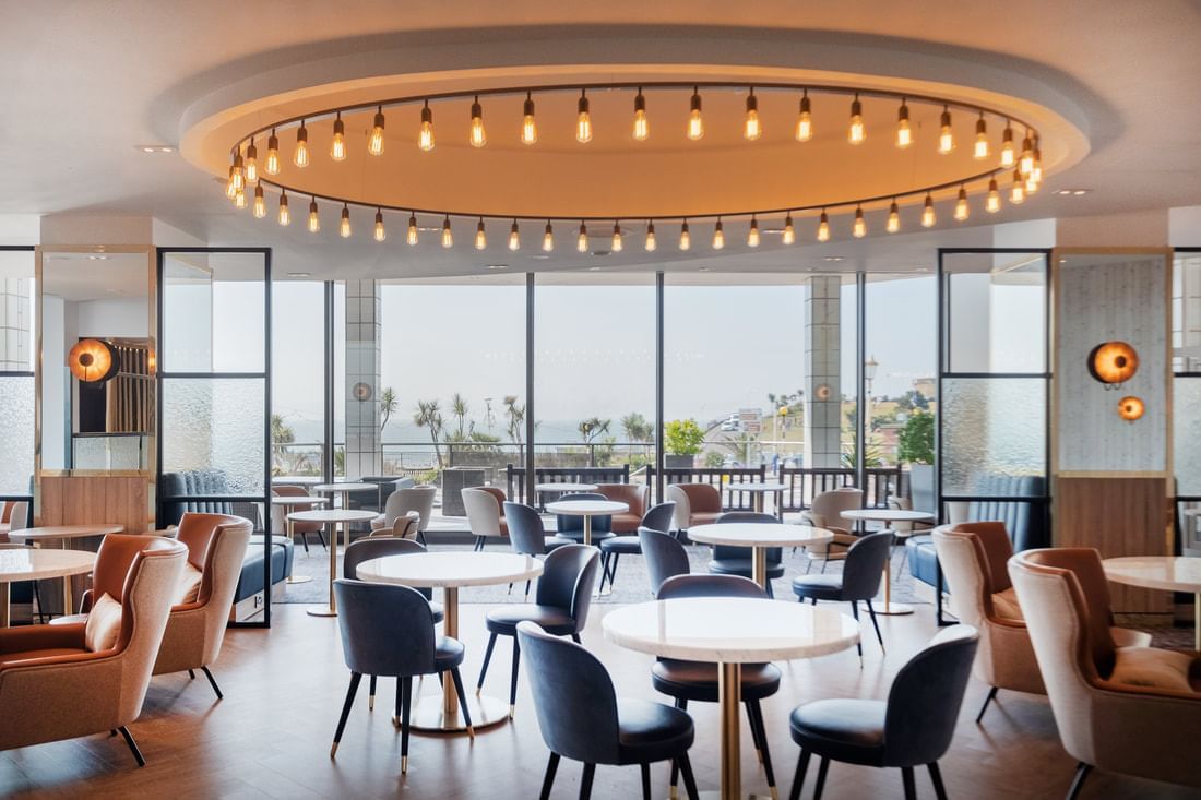 layout of vista bar cafe with lights glowing and view of the sea