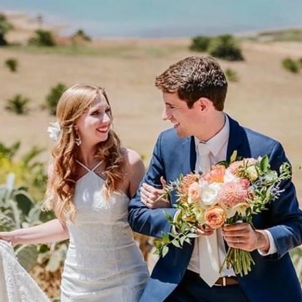 A bride and groom walking together in the desert near Catalina Island Company