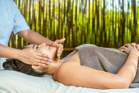 A woman having a massage in the spa at Hotel Isla Del Encanto