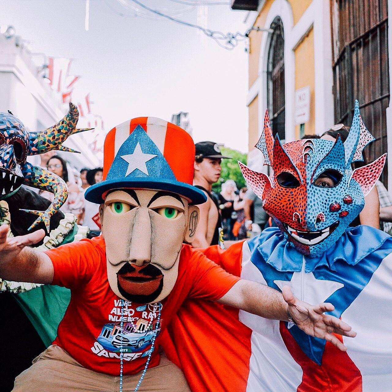 Festival of Calle San Sebastian with people in masks and costumes