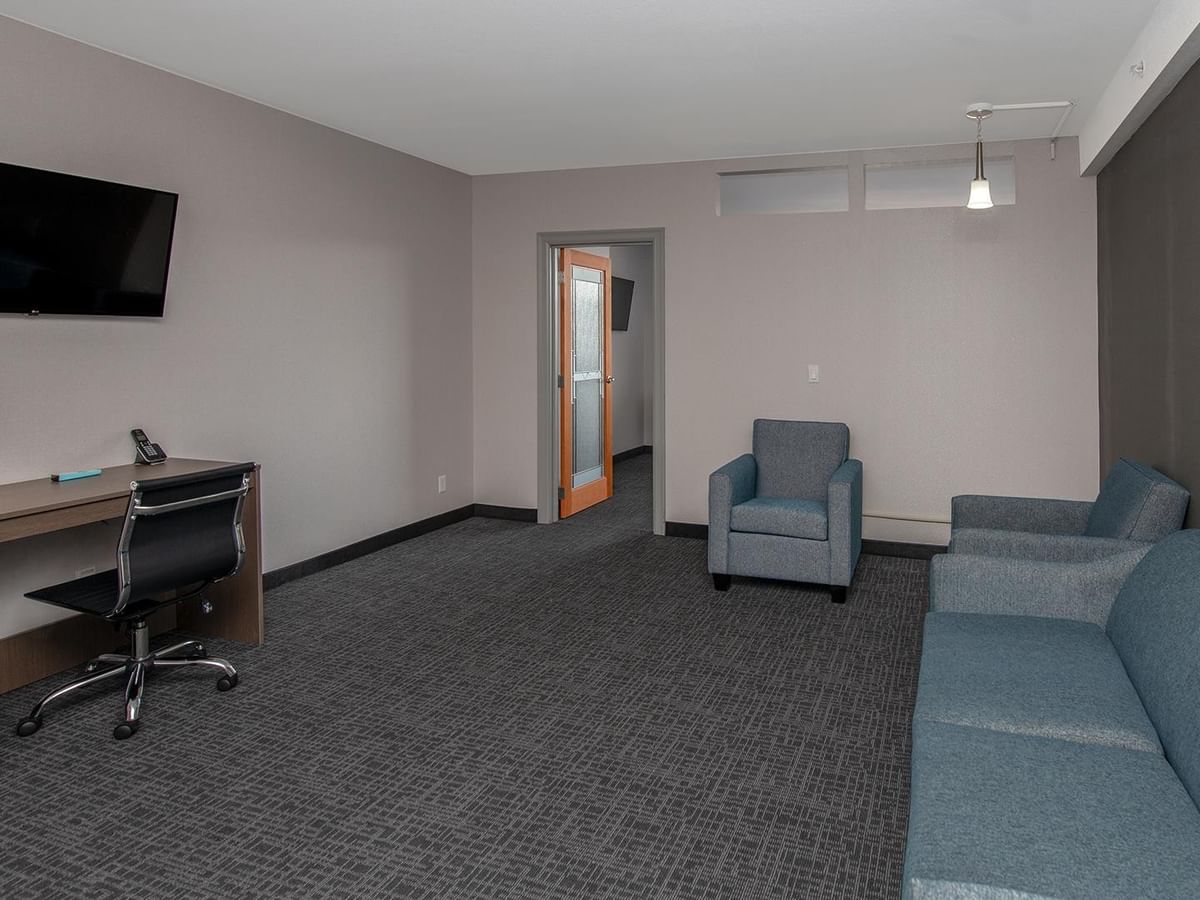 Couch, desk with lamp, TV, and chair.