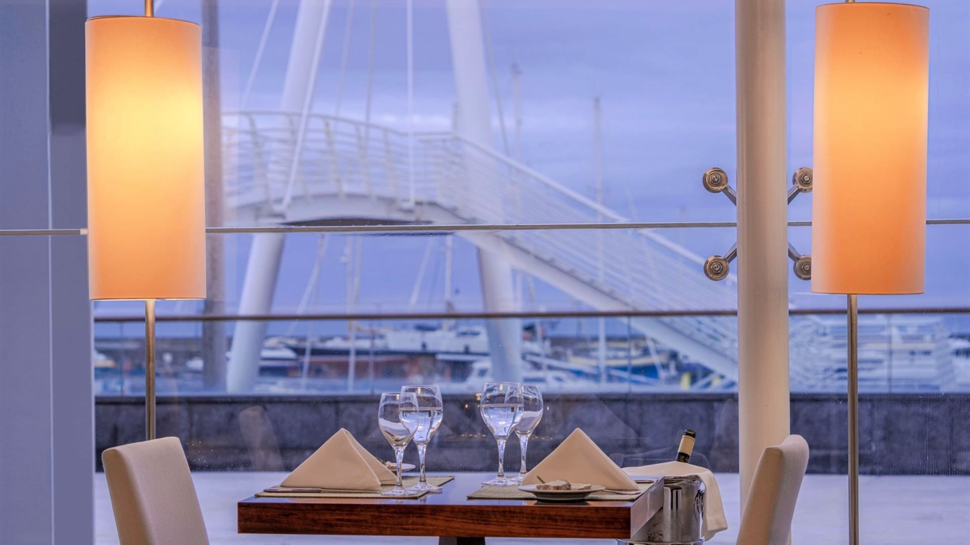 Dining table with culinary & harbor view in Escuna Restaurant at Hotel Marina Atlântico