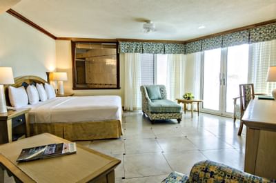 Interior of Deluxe Ocean View Suite with a king bed and lounge at Accra Hotels & Resorts