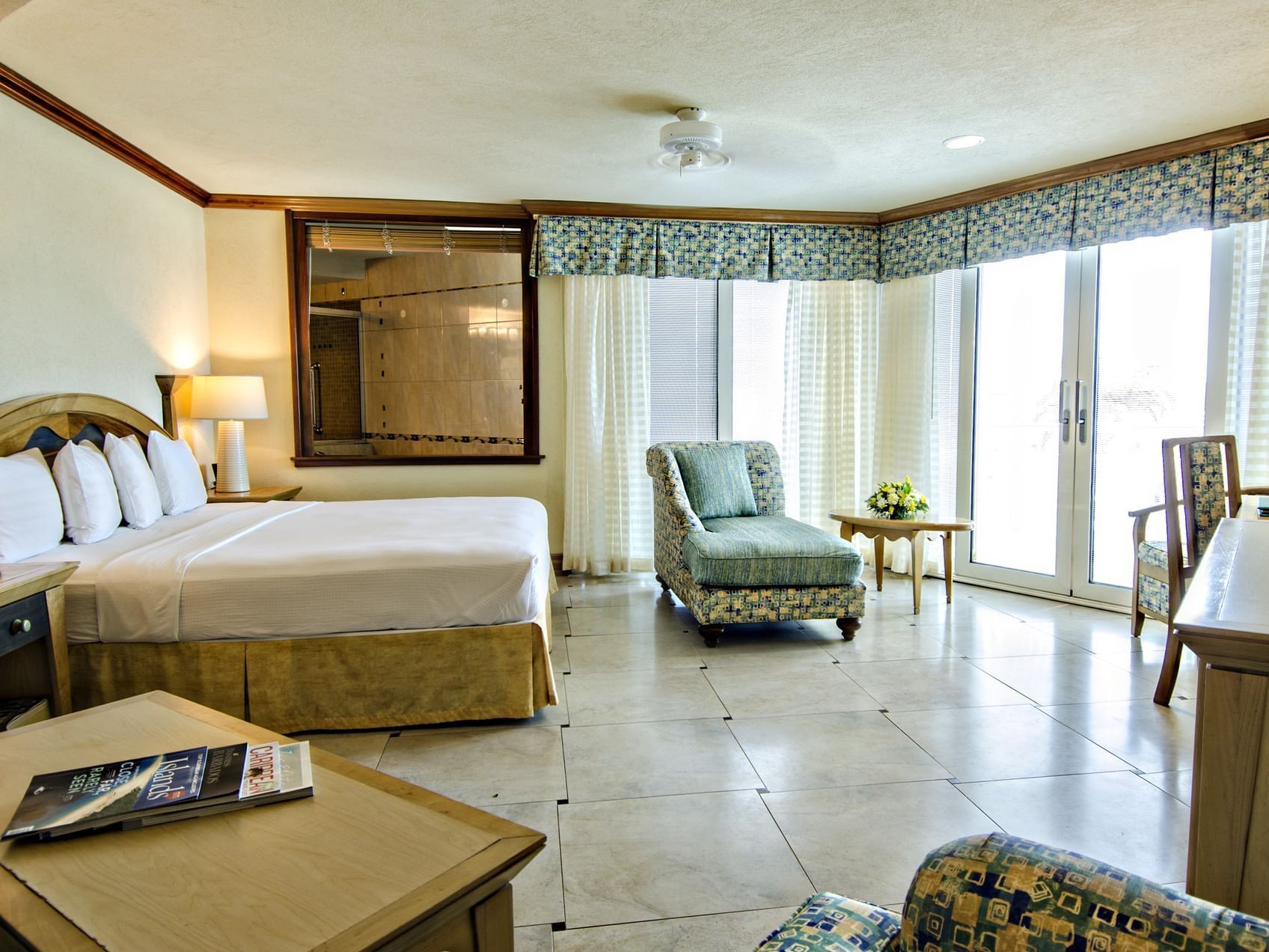 Interior of Deluxe Ocean View Suite with a king bed and lounge at Accra Hotels & Resorts