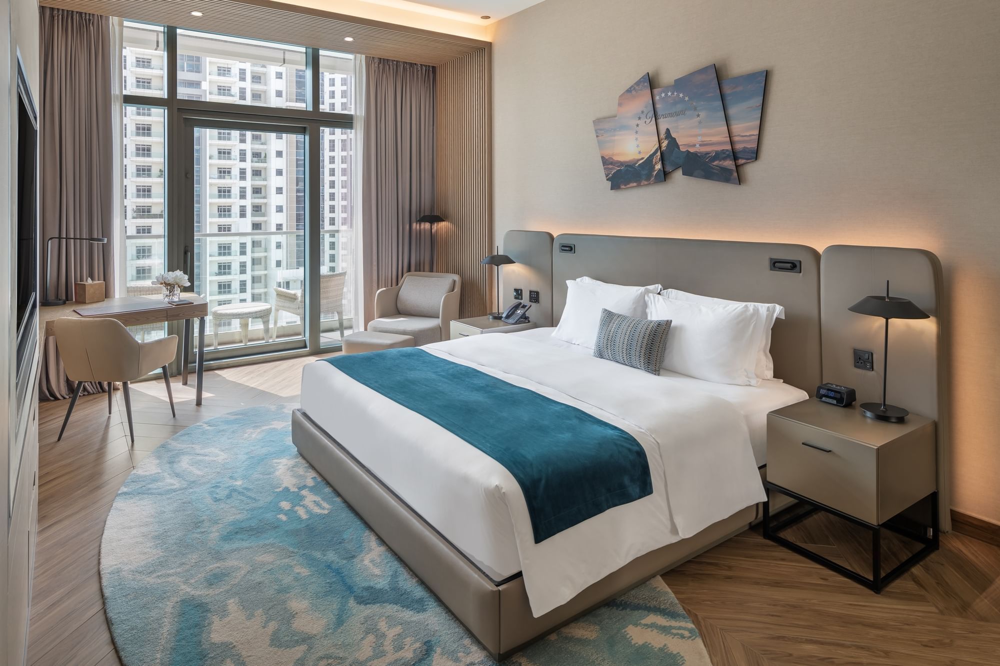 Workspace and cozy seating area by the bed in Scene Room with a city view at Paramount Hotel Midtown