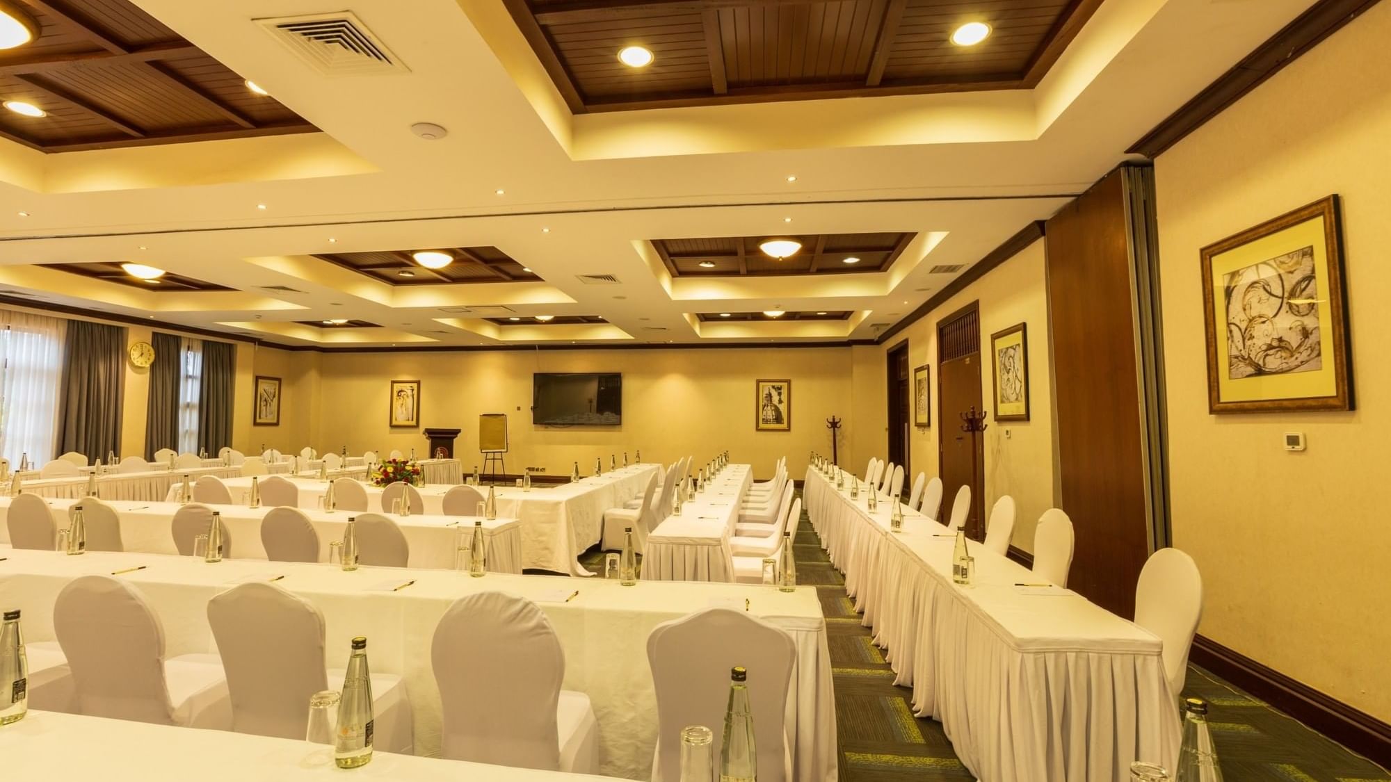 Elegant event room with white tables and chairs at Lake Victoria Serena Golf Resort & Spa in Kampala.