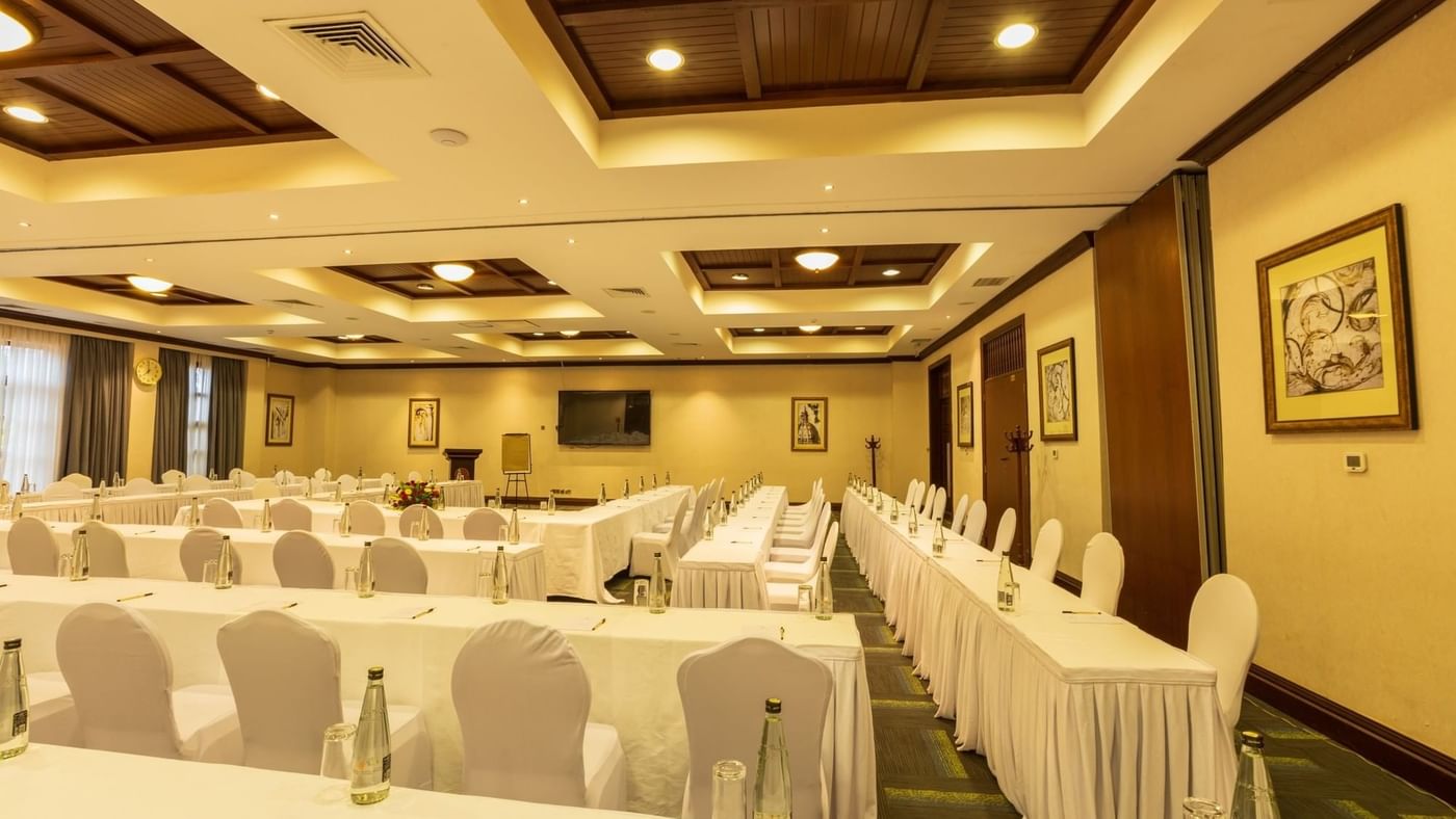 Elegant event room with white tables and chairs at Lake Victoria Serena Golf Resort & Spa in Kampala.