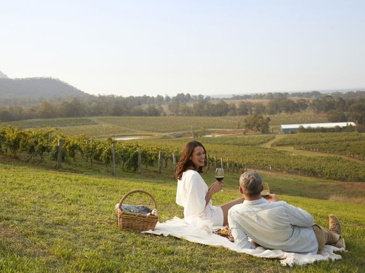 Two people enjoying a picnic in a vineyard near Mercure Kooindah Waters