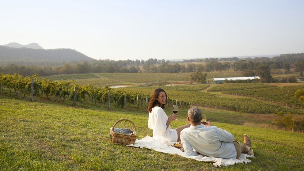 Two people enjoying a picnic in a Audrey Wilkinson Vineyard near Mercure Kooindah Waters