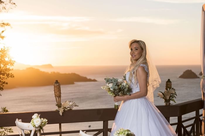 Bride on the balcony with a sea view at Villas Sol Beach Resort