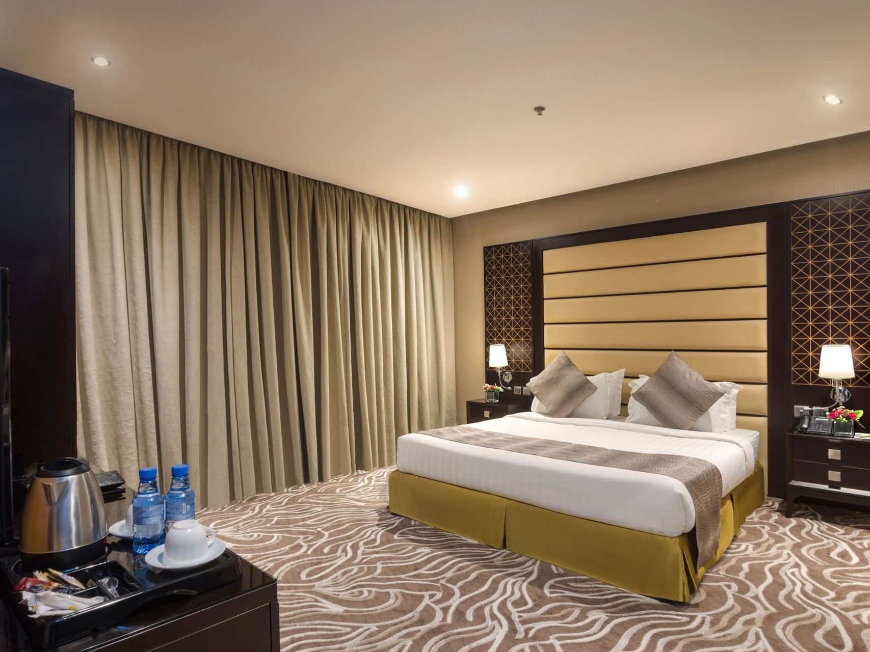 Bed with nightstand and window in Standard King Room at Warwick Hotels & Resorts